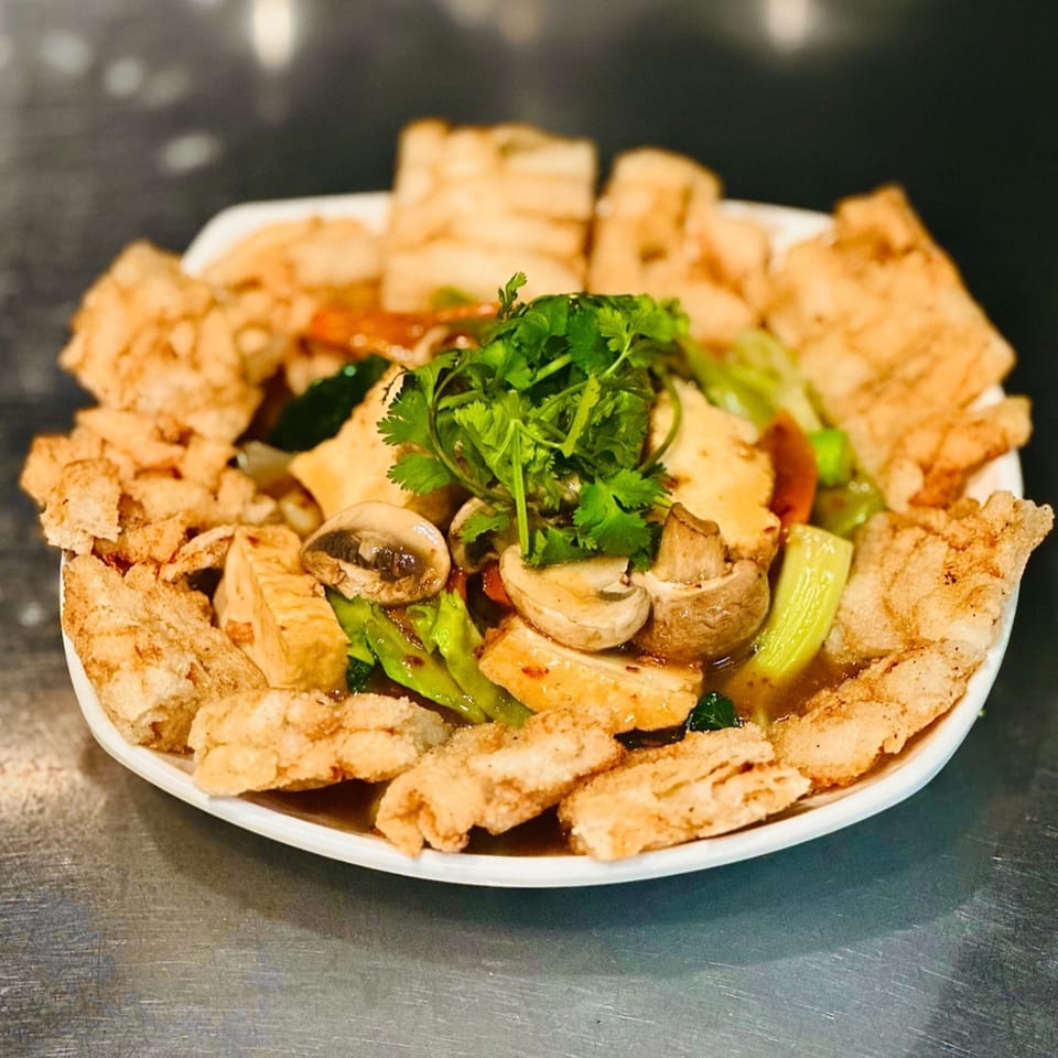 Blossom Vegan's crispy tofu dish with mushrooms, vegetables, and cilantro in a savory sauce.